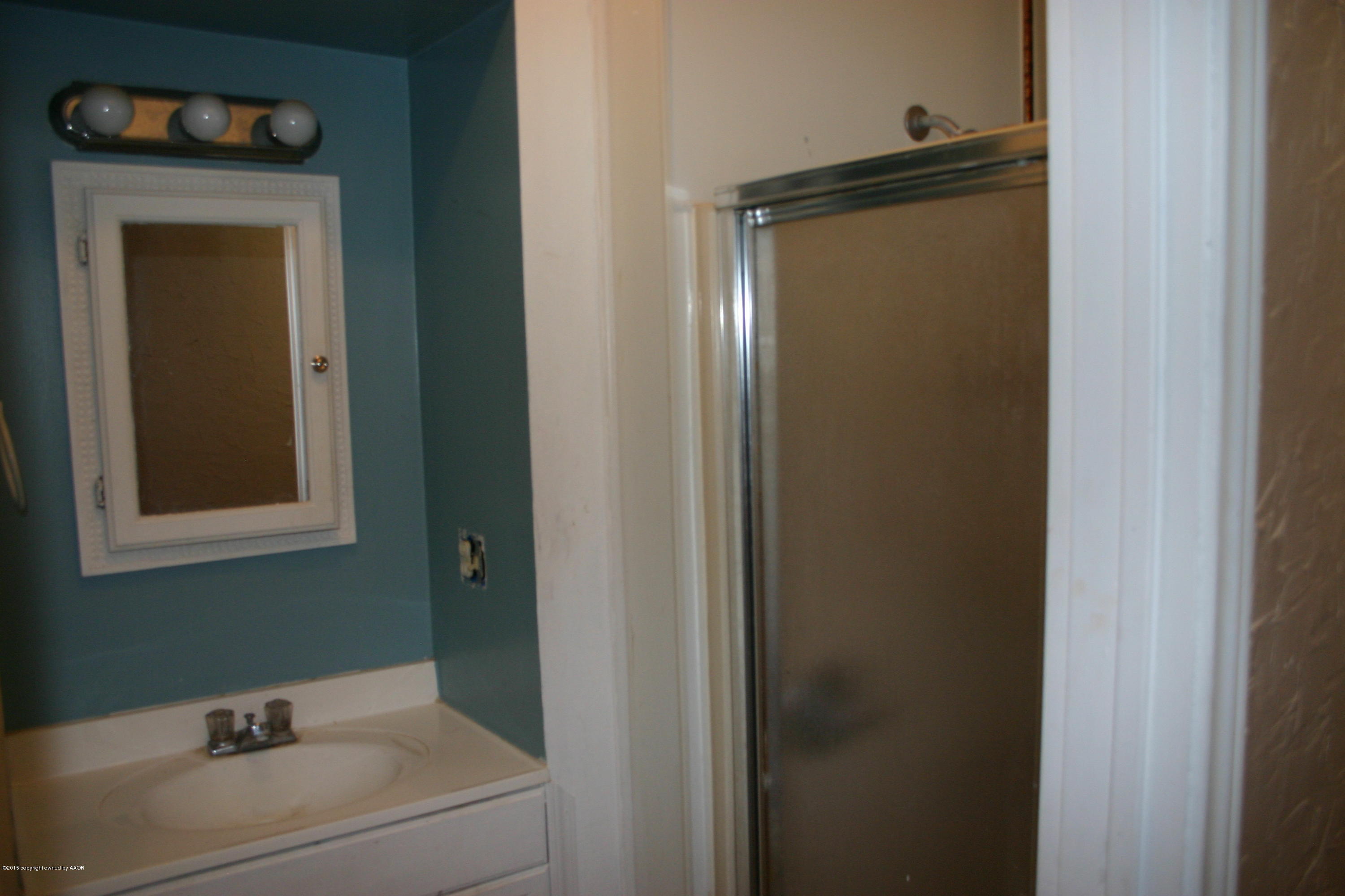 2214 South Taylor Street Amarillo, TX 79109 - Photo 18 of 30 a bathroom with a sink and a mirror