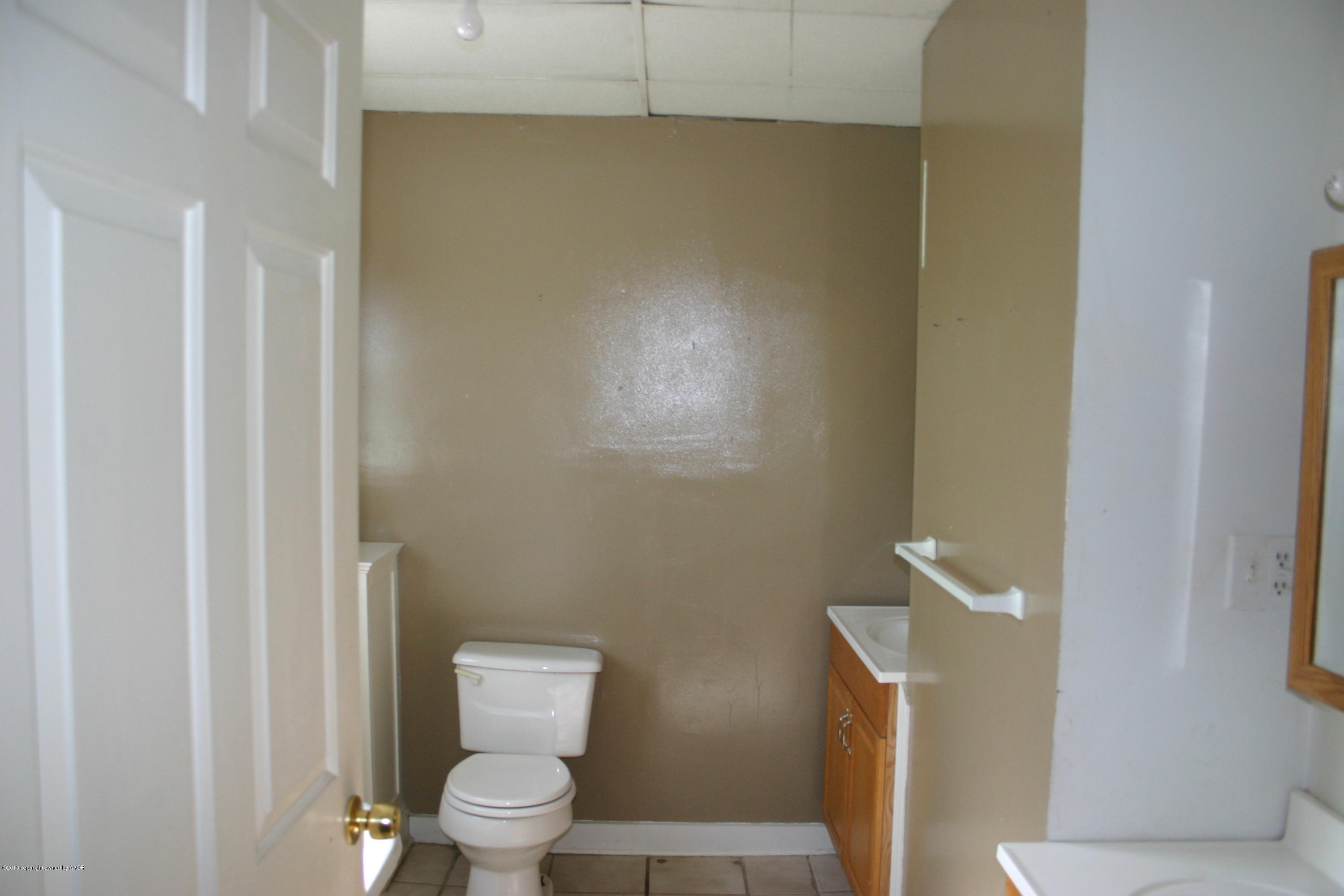 2214 South Taylor Street Amarillo, TX 79109 - Photo 24 of 30 a white toilet sitting next to a bathroom sink