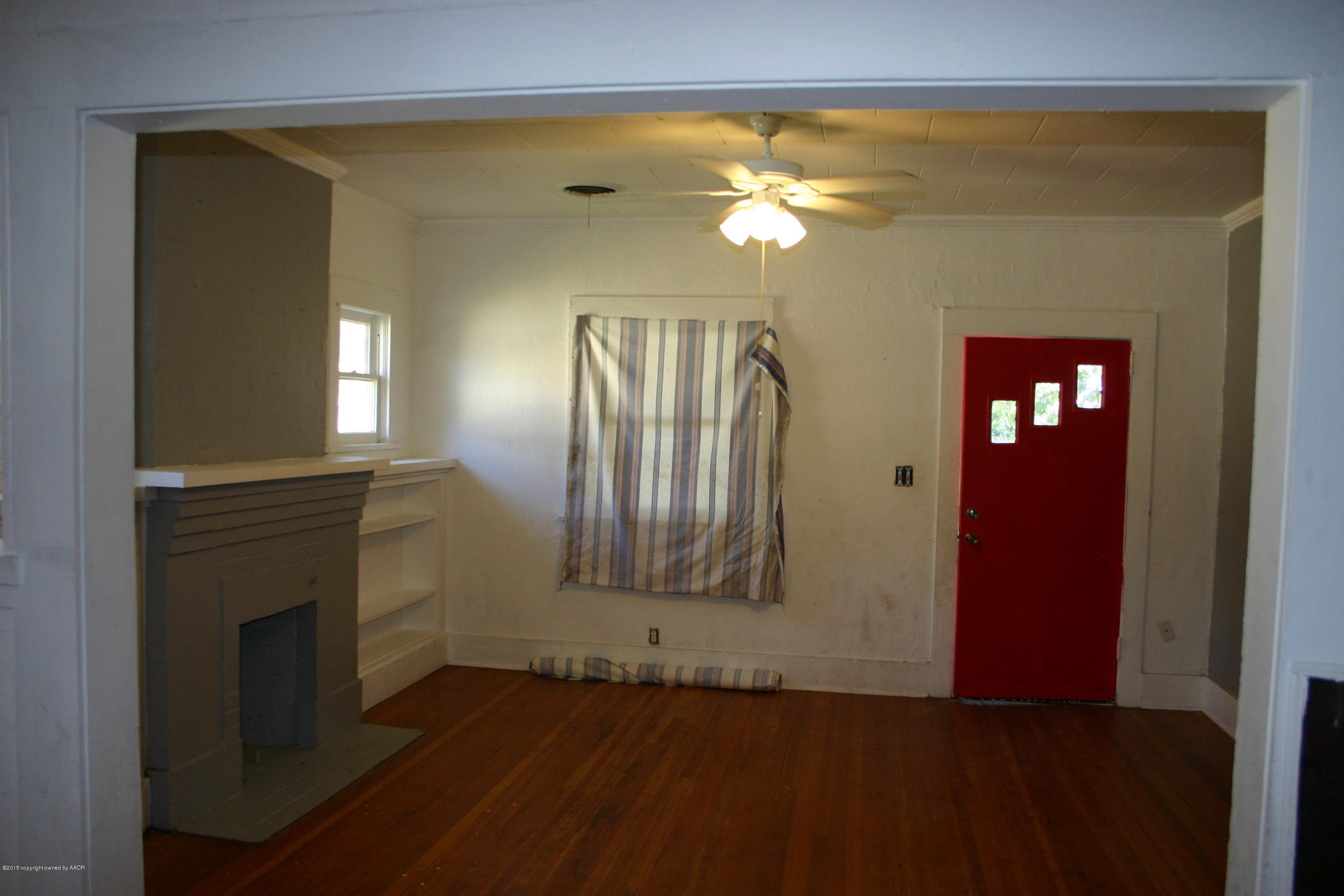 2214 South Taylor Street Amarillo, TX 79109 - Photo 6 of 30 a view of a livingroom with wooden floor and a fireplace