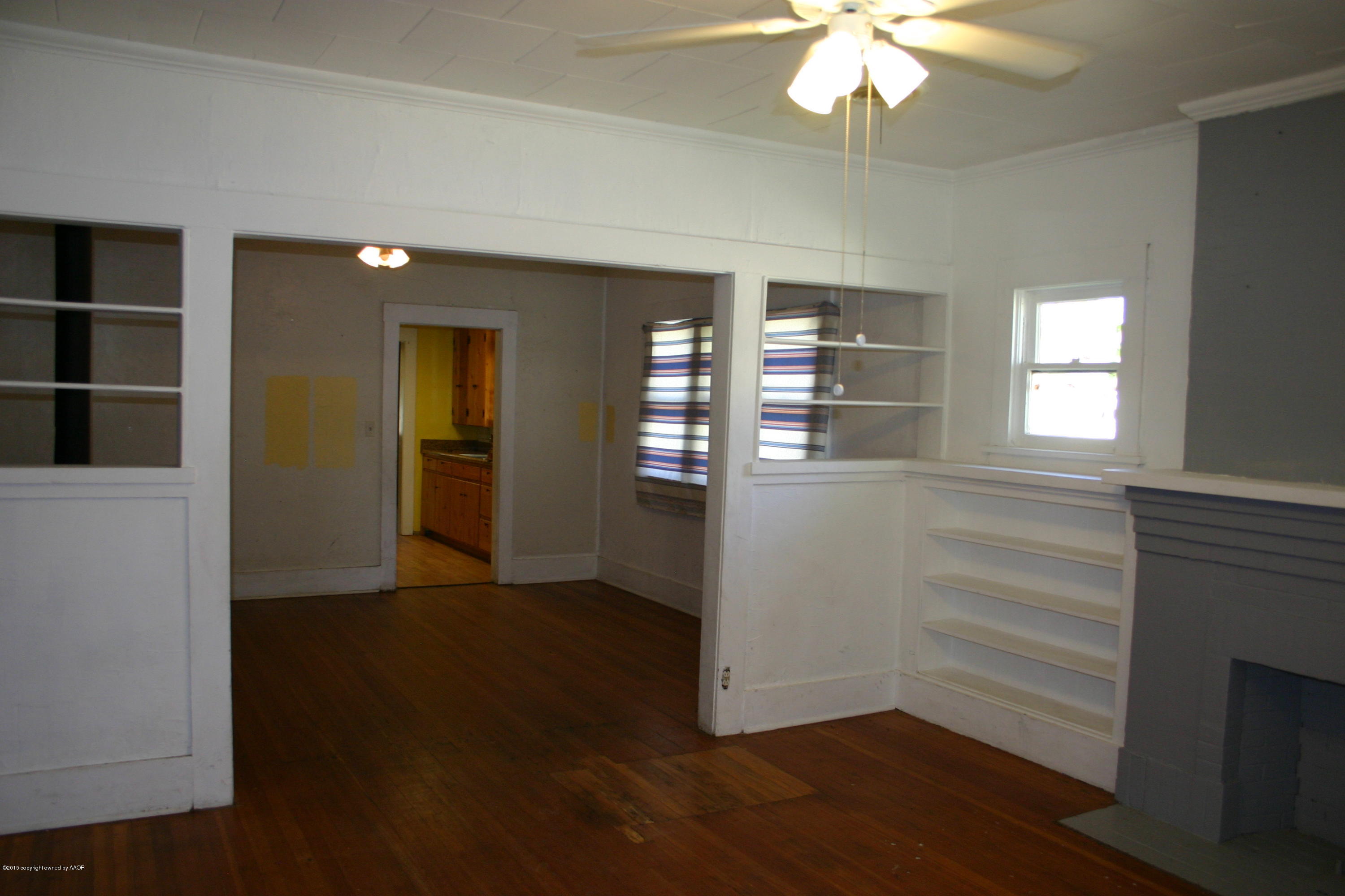 2214 South Taylor Street Amarillo, TX 79109 - Photo 8 of 30 wooden floor in an empty room with a window