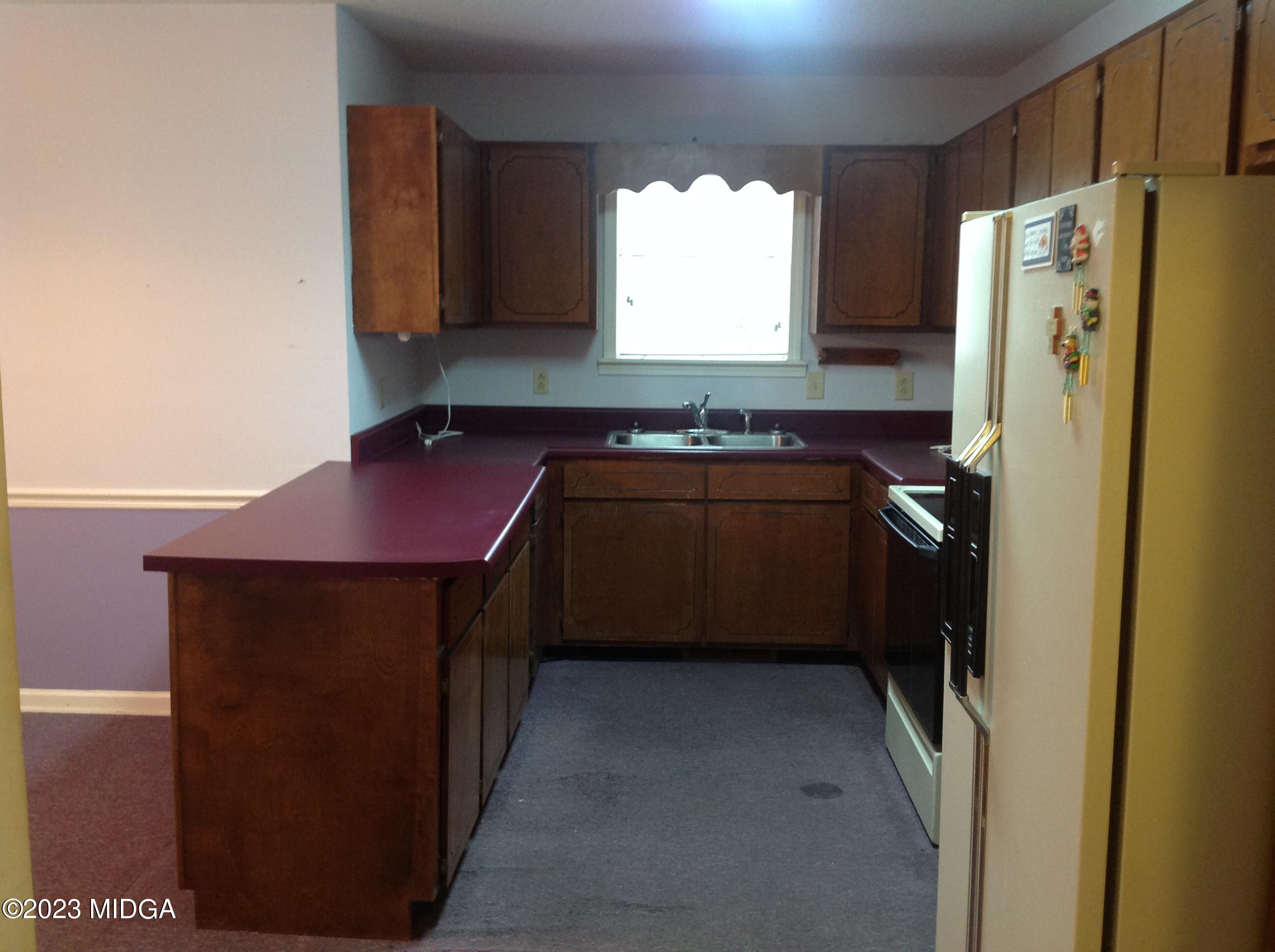6251 Columbus Road Macon, GA 31206 - Photo 8 of 33 a kitchen with a refrigerator and a sink