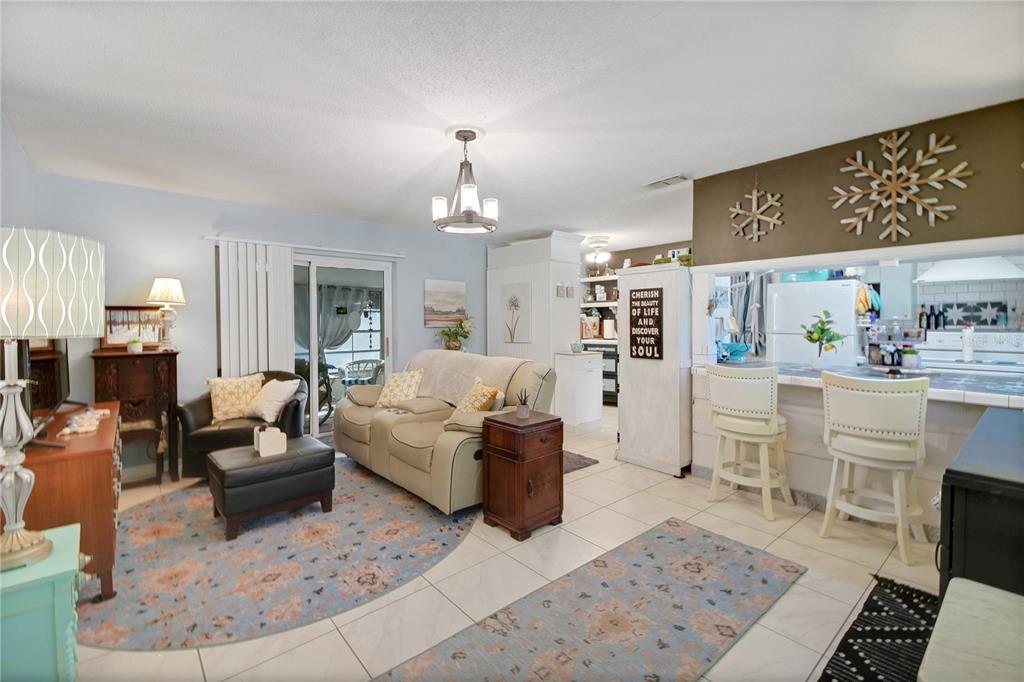 6122 East Glencoe Street Inverness, FL 34452 - Photo 14 of 37 a living room with furniture and a chandelier