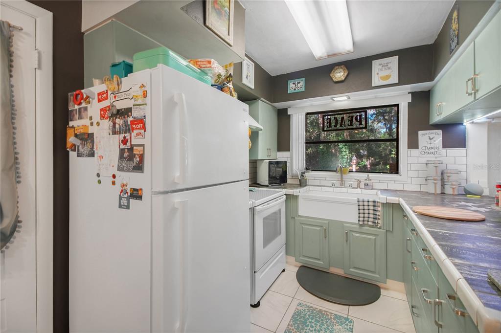 6122 East Glencoe Street Inverness, FL 34452 - Photo 15 of 37 a white refrigerator freezer sitting inside of a kitchen