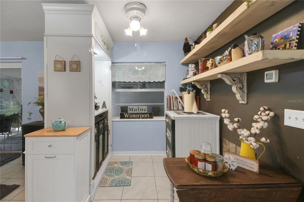 6122 East Glencoe Street Inverness, FL 34452 - Photo 18 of 37 a kitchen with stainless steel appliances kitchen island granite countertop a refrigerator and a stove