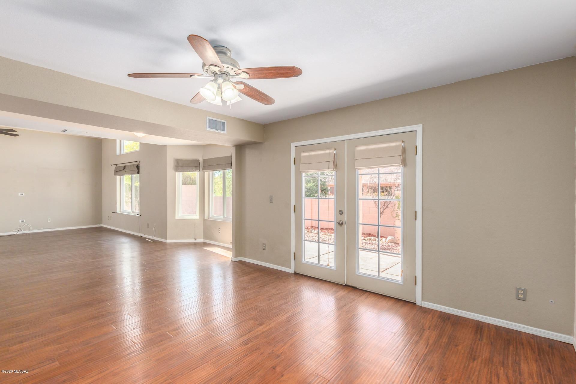 3580 West Sky Ridge Loop Tucson, AZ 85742 - Photo 11 of 29 a view of an empty room with a window and wooden floor