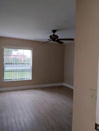 wooden floor in an empty room with a window