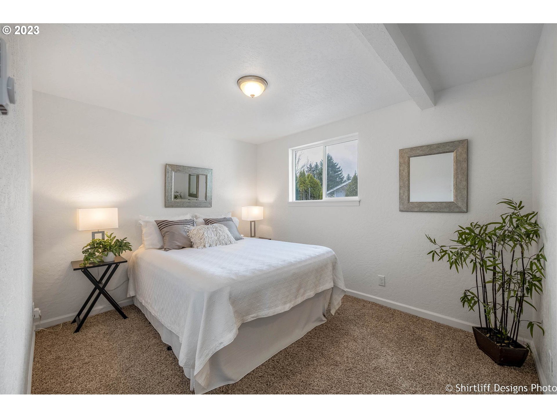 1446 E Street Springfield, OR 97477 - Photo 14 of 26 a bedroom with a bed and a potted plant