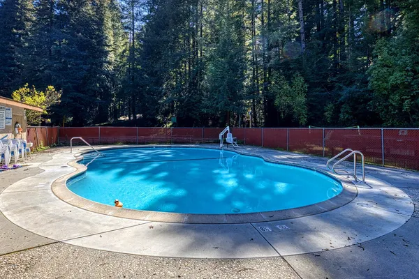 a view of a swimming pool with a yard