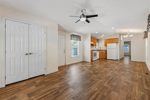 a view of a kitchen with a sink and wooden floor