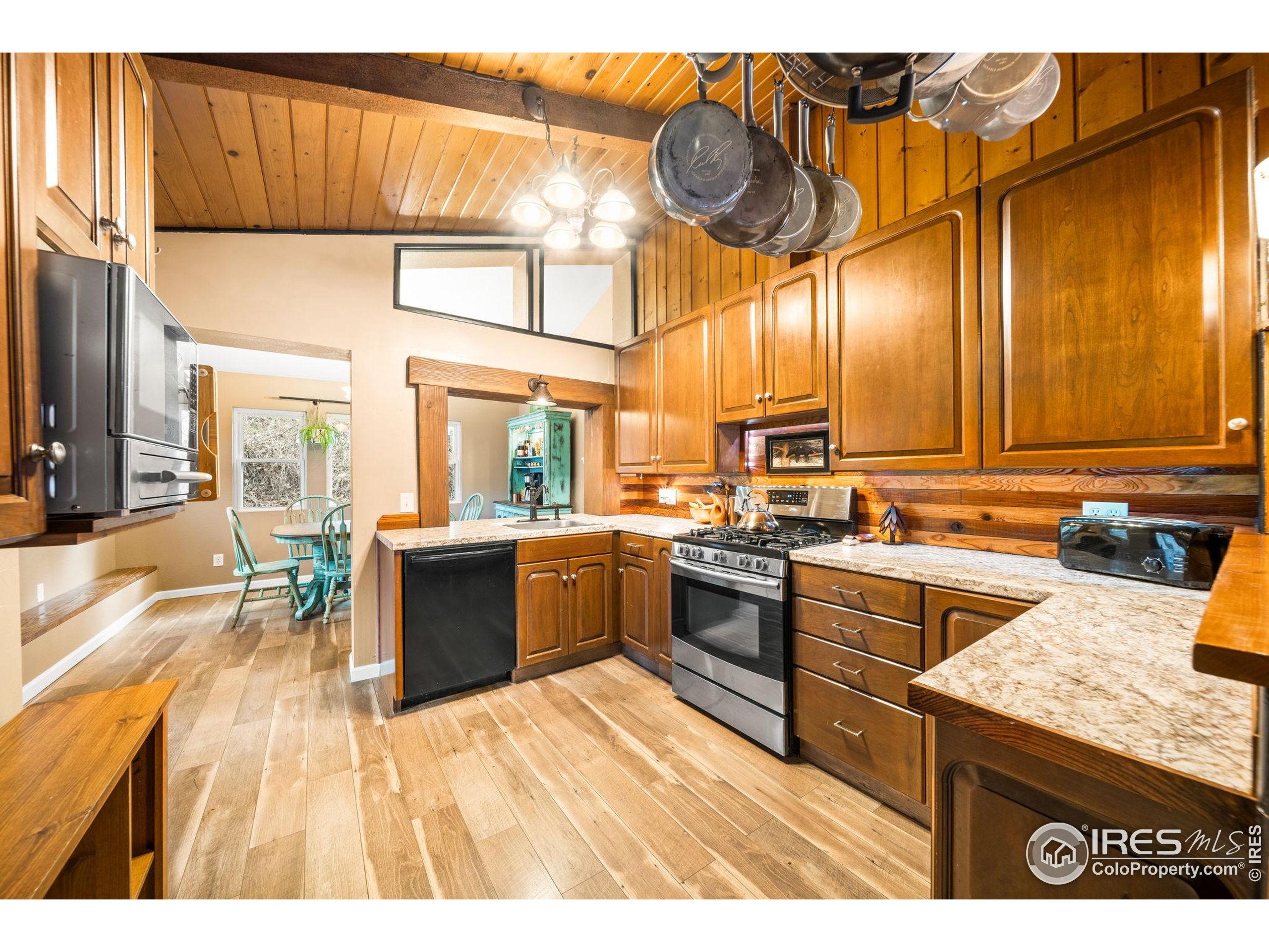 24 Tracy Trail Road Loveland, CO 80537 - Photo 11 of 34 a kitchen with stainless steel appliances granite countertop a stove and cabinets