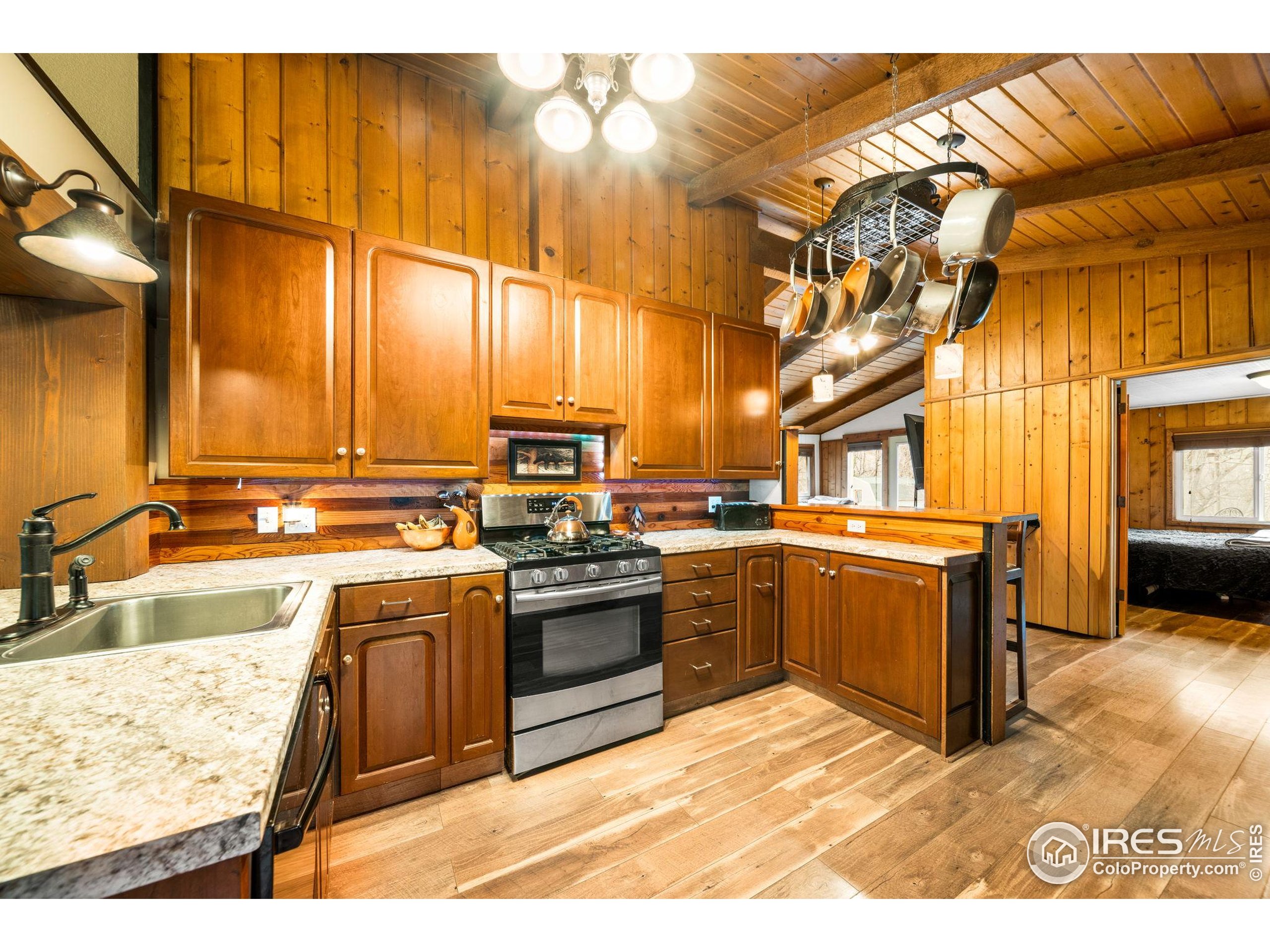 24 Tracy Trail Road Loveland, CO 80537 - Photo 12 of 34 a kitchen with stainless steel appliances granite countertop a sink and cabinets