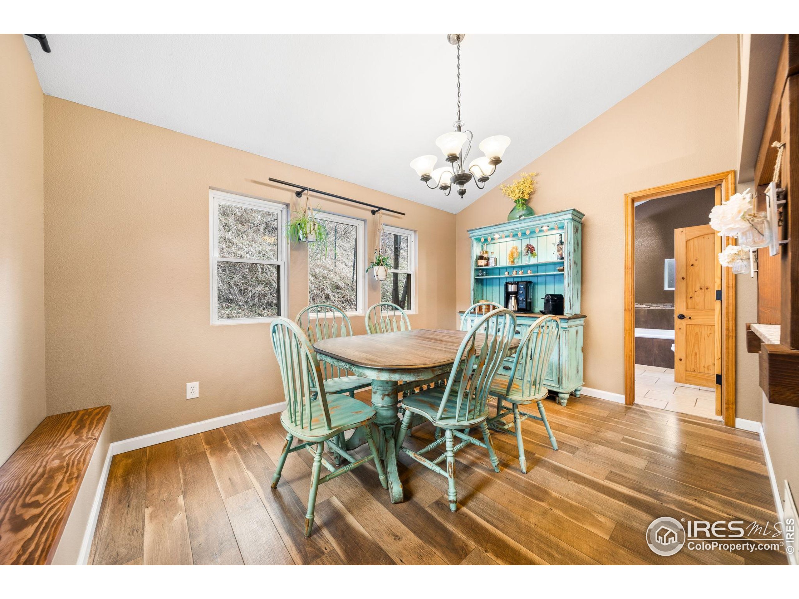 24 Tracy Trail Road Loveland, CO 80537 - Photo 13 of 34 a view of a dining room with furniture window and wooden floor
