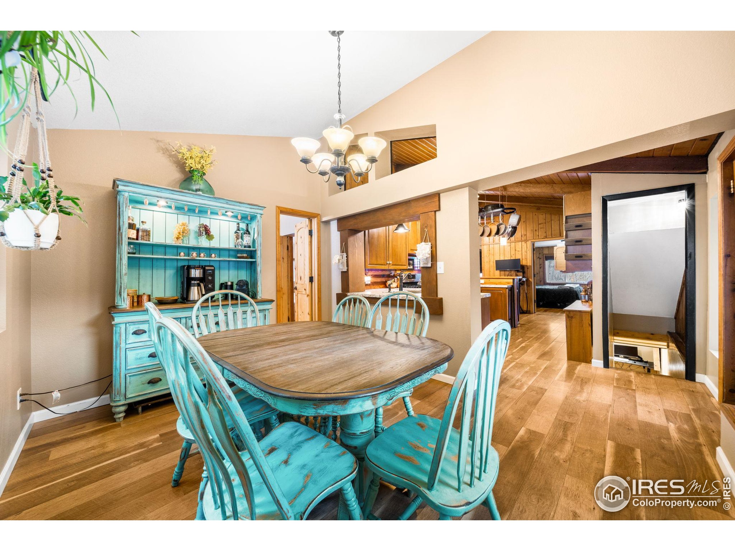 24 Tracy Trail Road Loveland, CO 80537 - Photo 15 of 34 a dining room with furniture a floor to ceiling window and potted plants