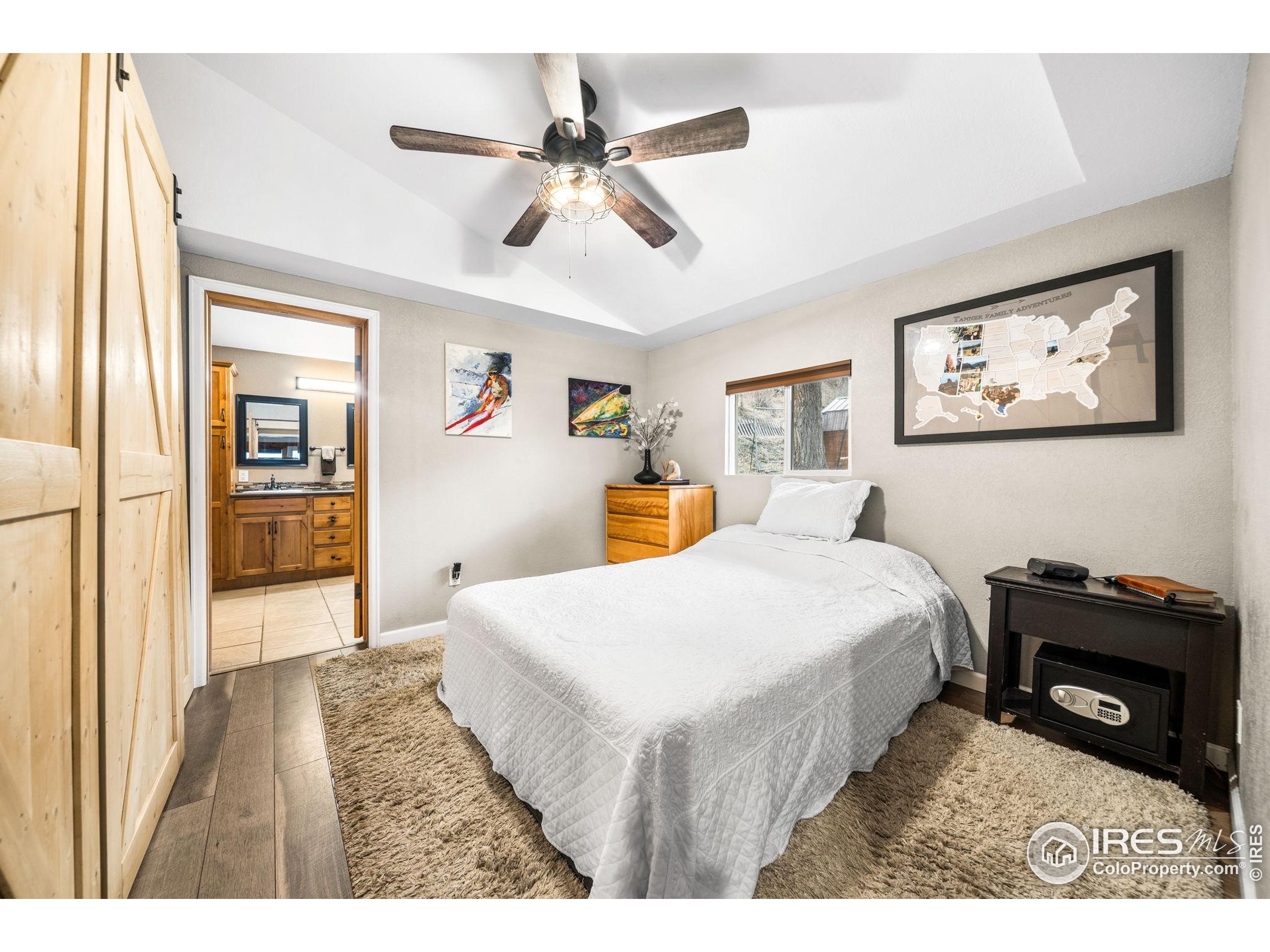 24 Tracy Trail Road Loveland, CO 80537 - Photo 19 of 34 a bedroom with a bed and a dresser