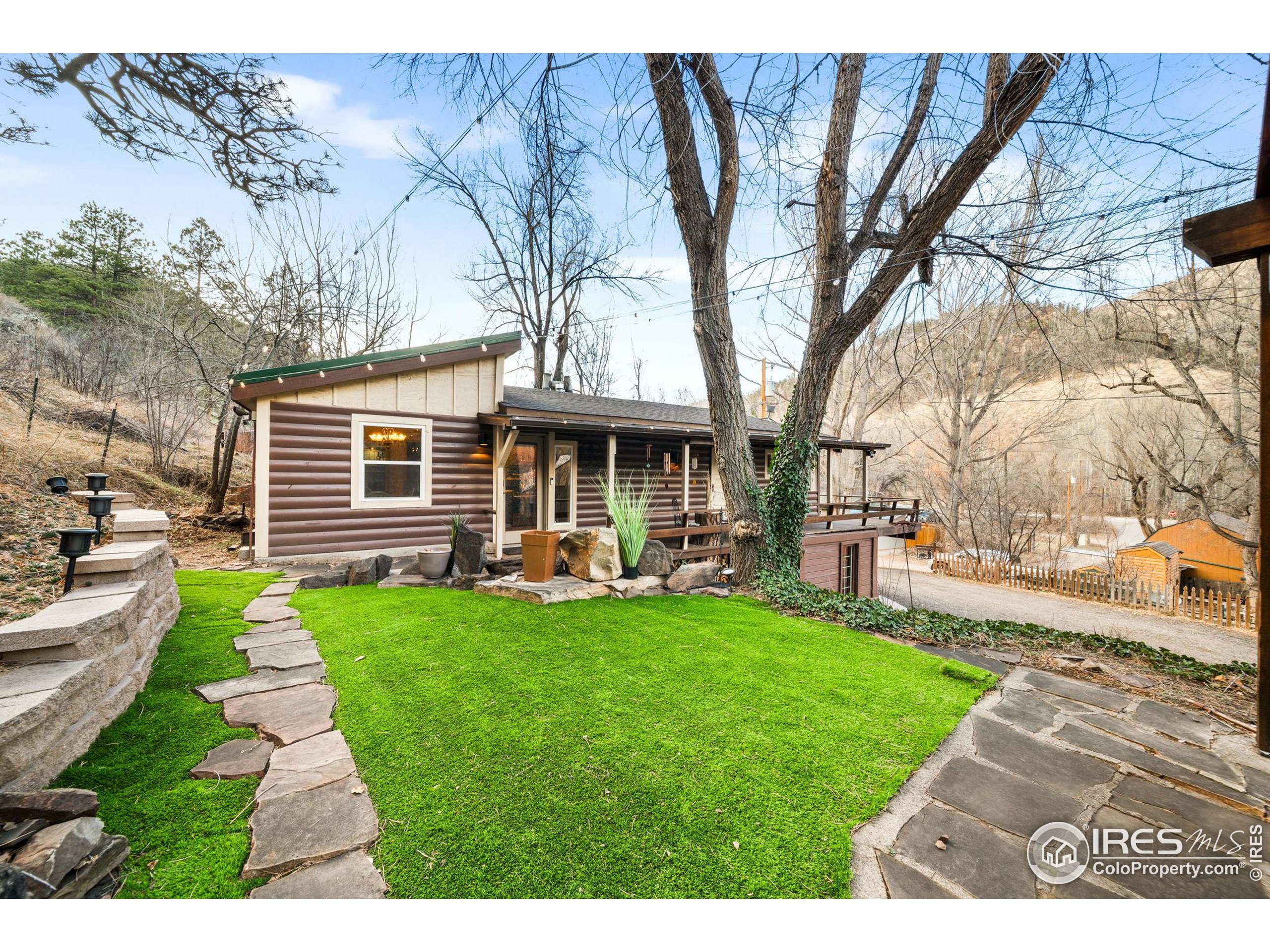 24 Tracy Trail Road Loveland, CO 80537 - Photo 2 of 34 a view of a house with a yard porch and sitting area