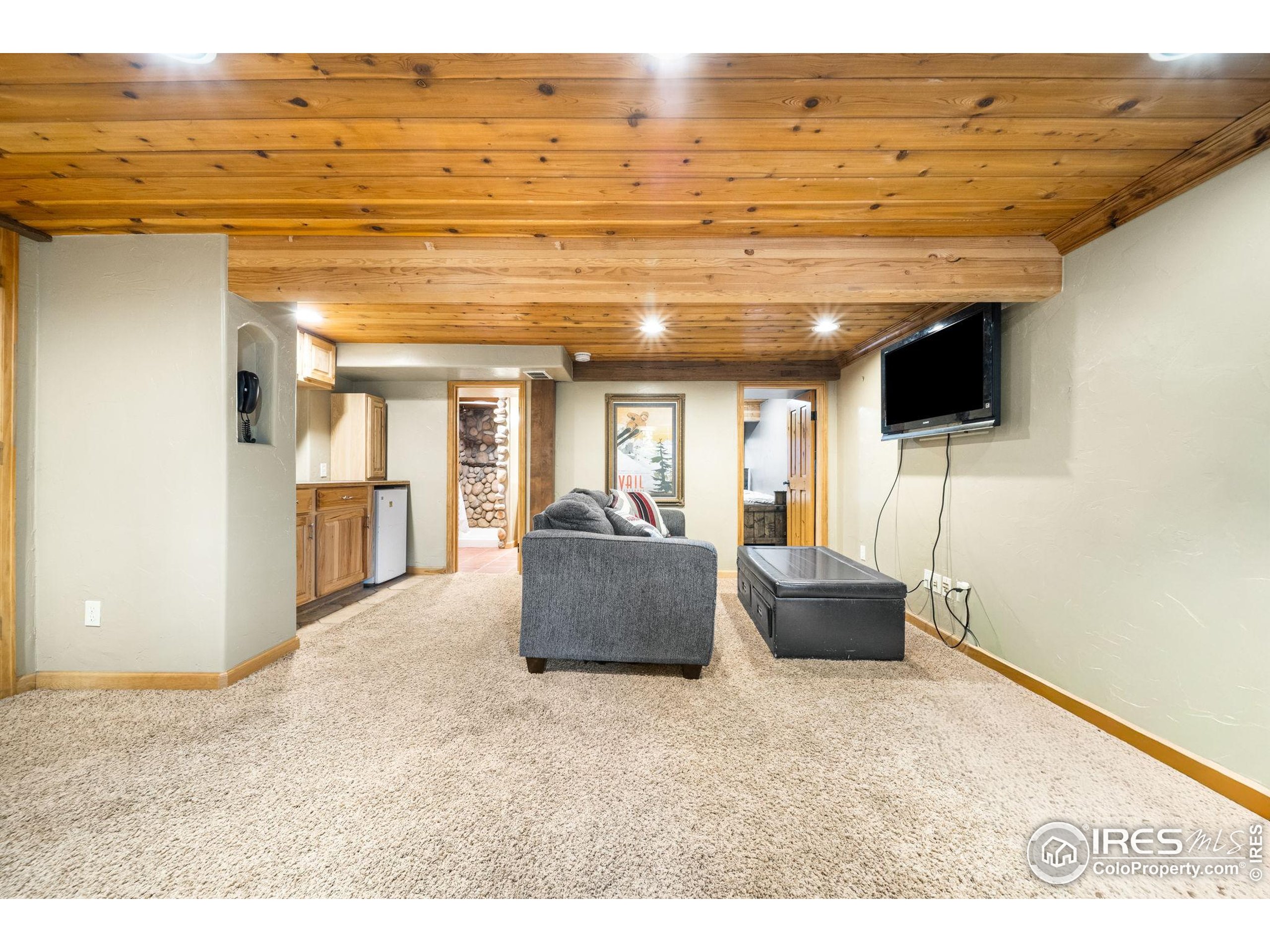 24 Tracy Trail Road Loveland, CO 80537 - Photo 22 of 34 a living room with furniture and a flat screen tv