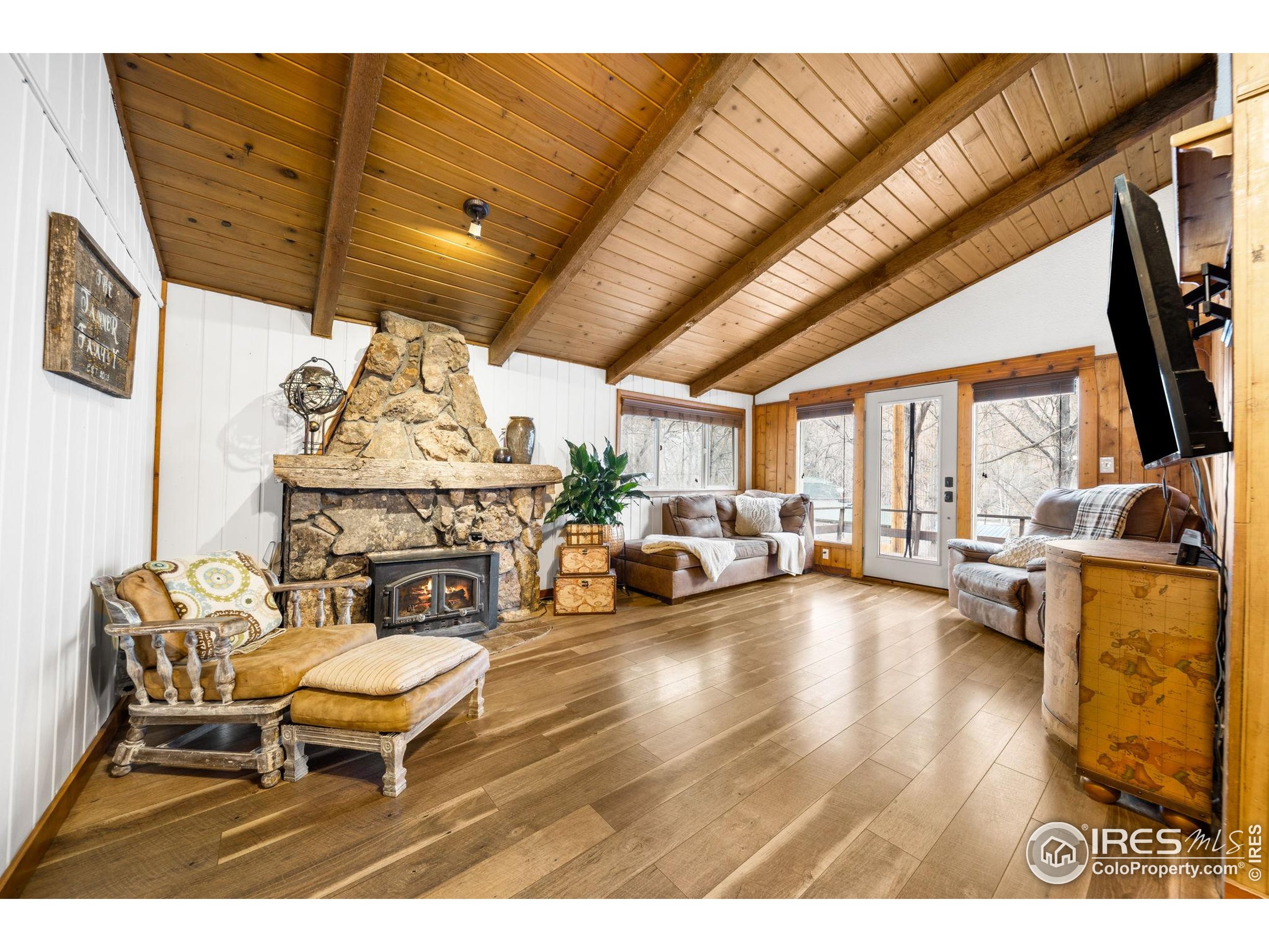24 Tracy Trail Road Loveland, CO 80537 - Photo 7 of 34 a living room with furniture a fireplace and a flat screen tv