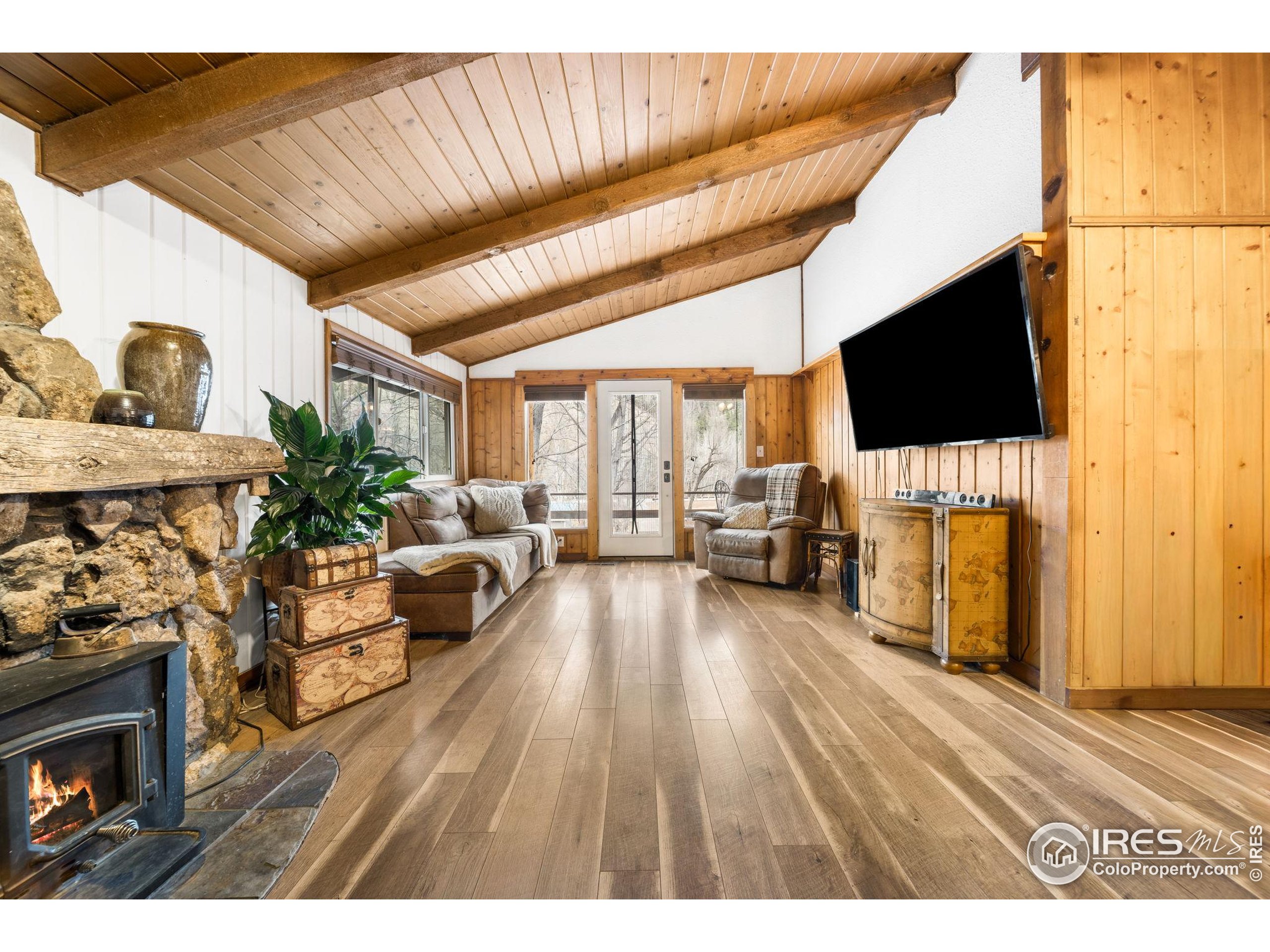 24 Tracy Trail Road Loveland, CO 80537 - Photo 8 of 34 a living room with furniture and a flat screen tv