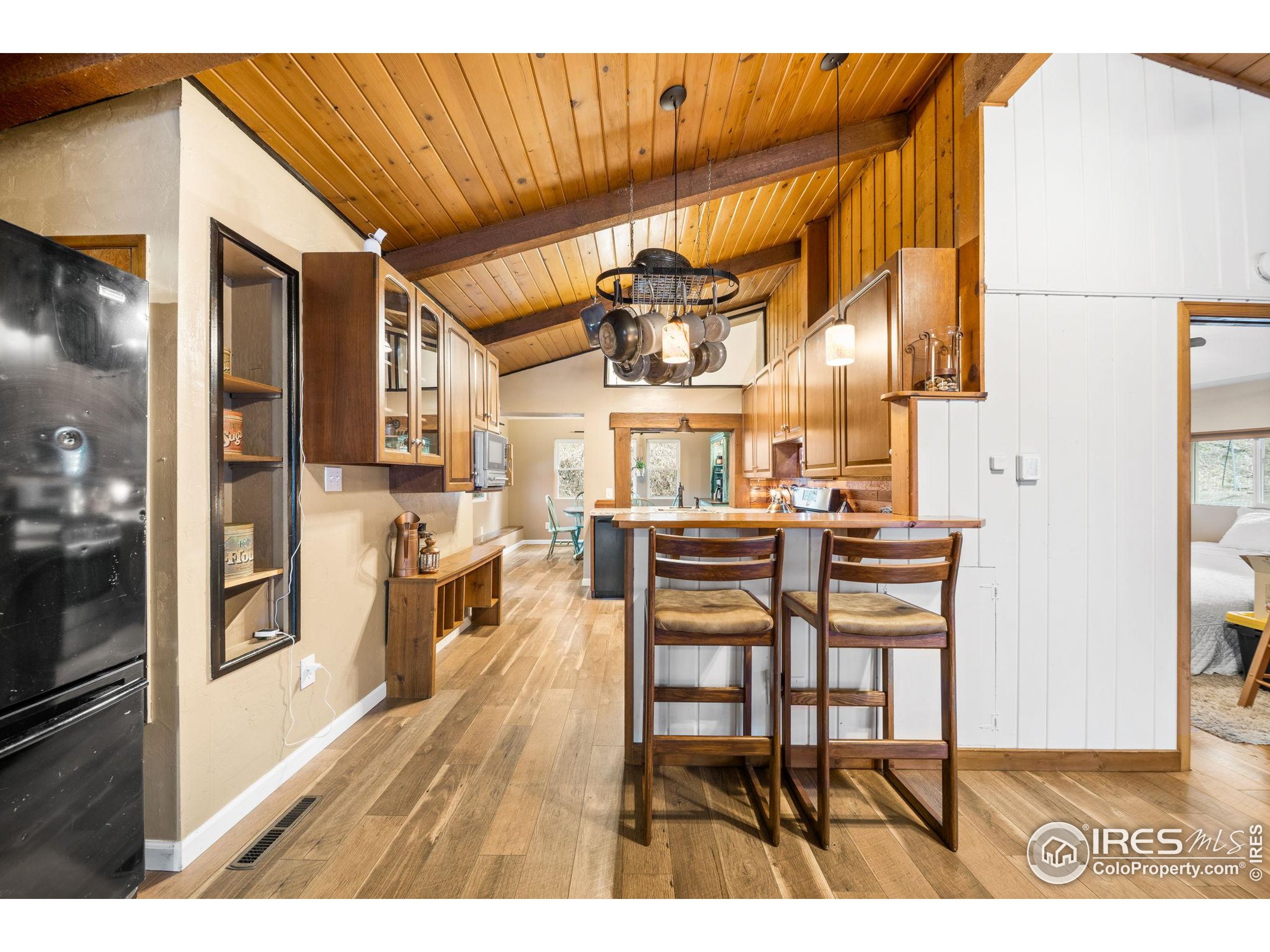 24 Tracy Trail Road Loveland, CO 80537 - Photo 9 of 34 a view of a dining room with furniture and wooden floor
