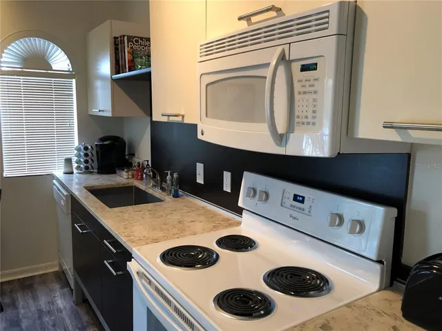 a kitchen with a stove and a microwave