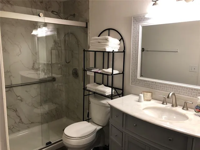 a bathroom with a sink toilet and shower