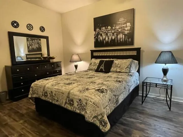 a bed sitting in a bedroom and painting on the wall