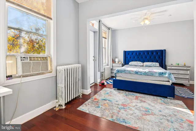 a bedroom with a bed and a window