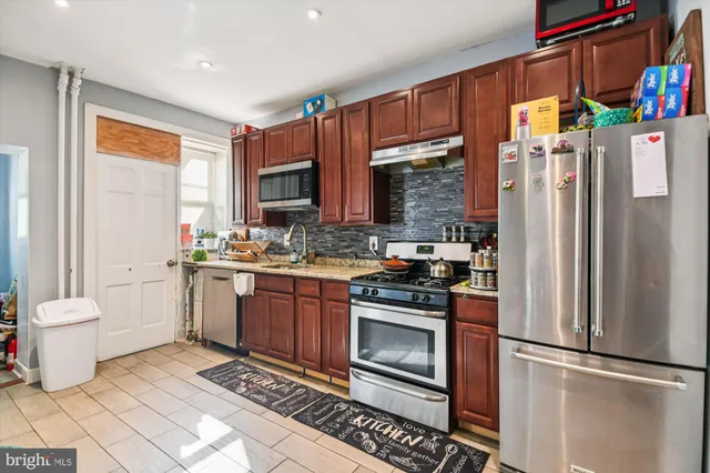 a kitchen with a refrigerator sink and stove