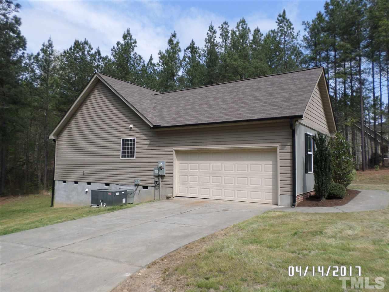 3993 Range Road Stem, NC 27581 - Photo 11 of 12 a view of a house with a yard and garage