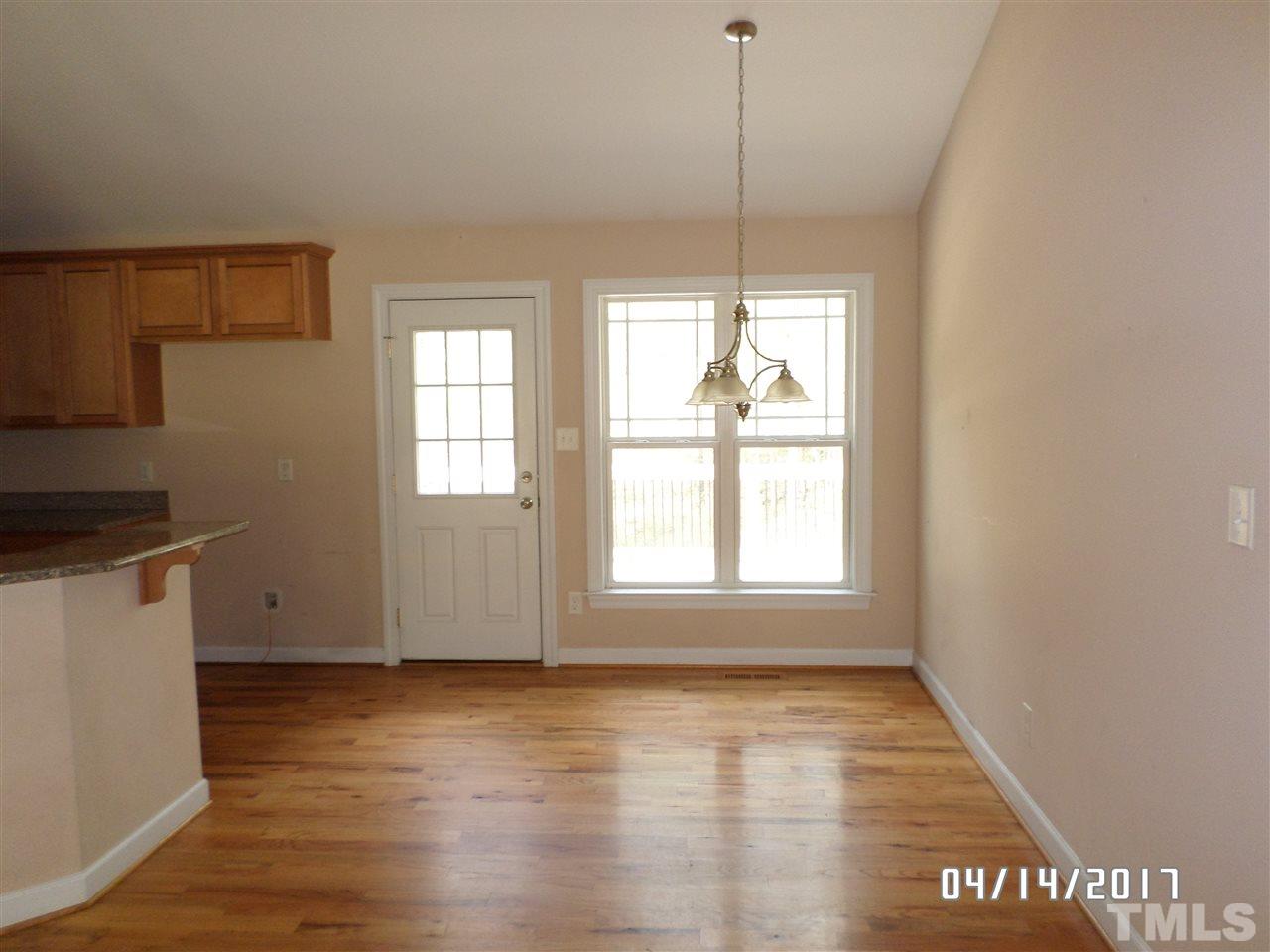 3993 Range Road Stem, NC 27581 - Photo 3 of 12 a view of an empty room with wooden floor and a window