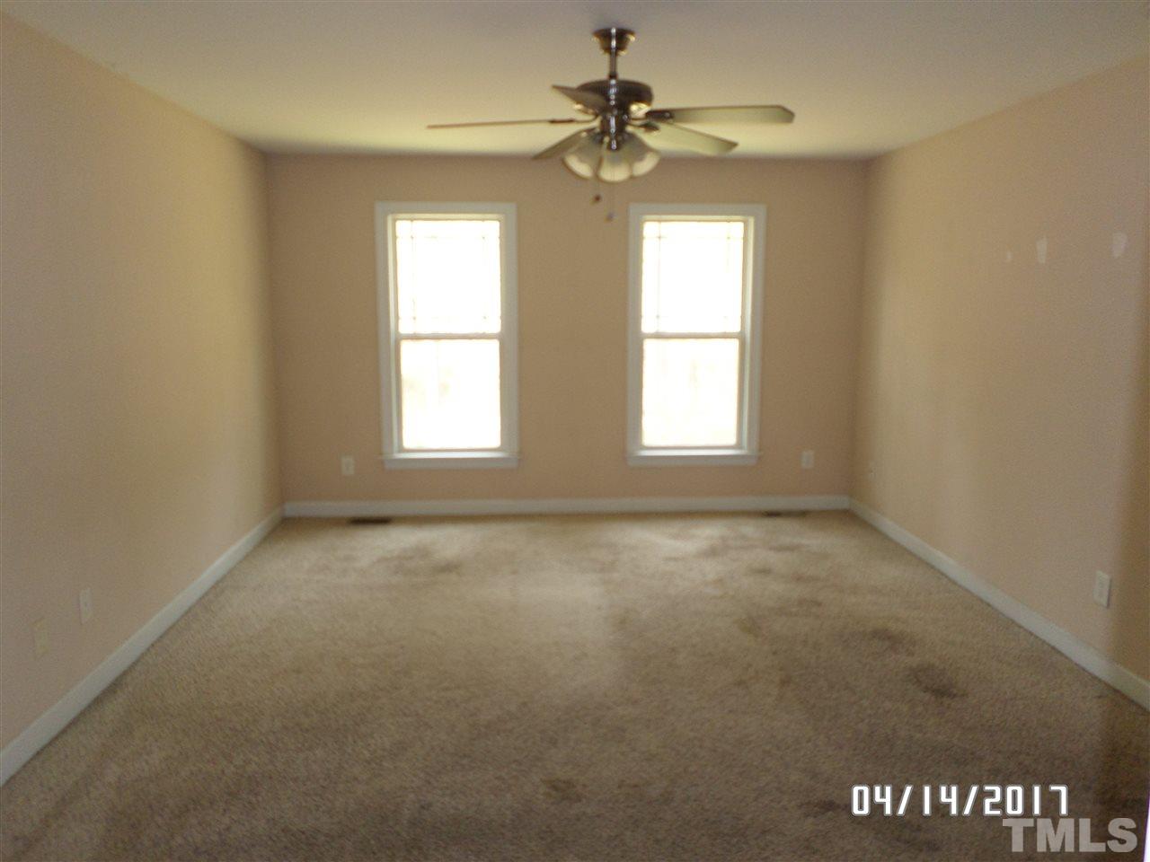 3993 Range Road Stem, NC 27581 - Photo 6 of 12 an empty room with windows and fan
