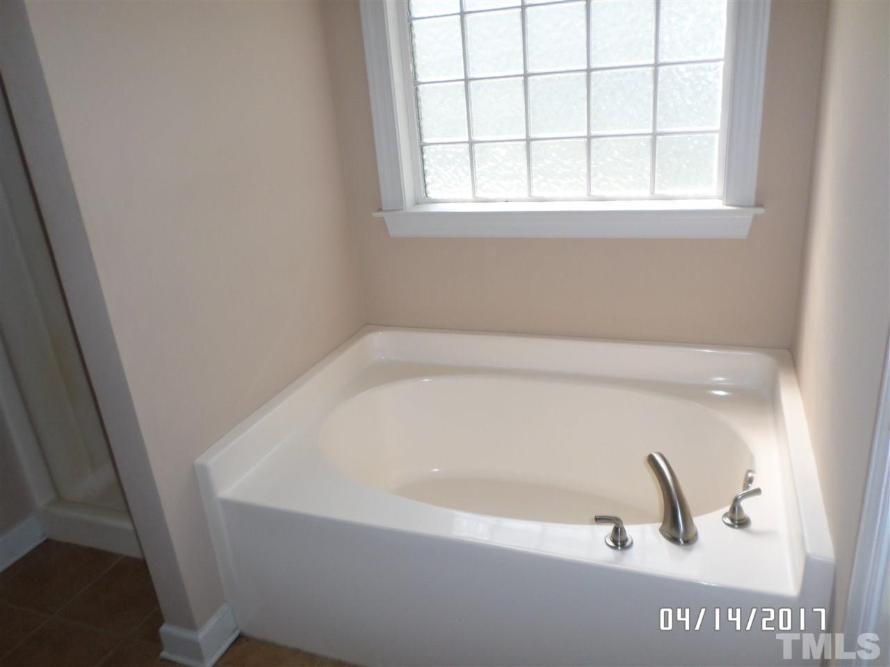 3993 Range Road Stem, NC 27581 - Photo 7 of 12 a bathroom with a bathtub