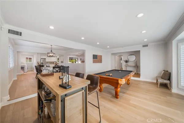 a living room with furniture a table and wooden floor