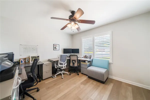 a view of a livingroom with workspace and a window