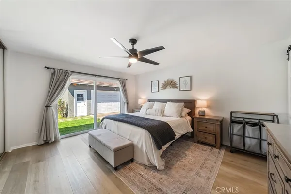a spacious bedroom with a bed and a large window