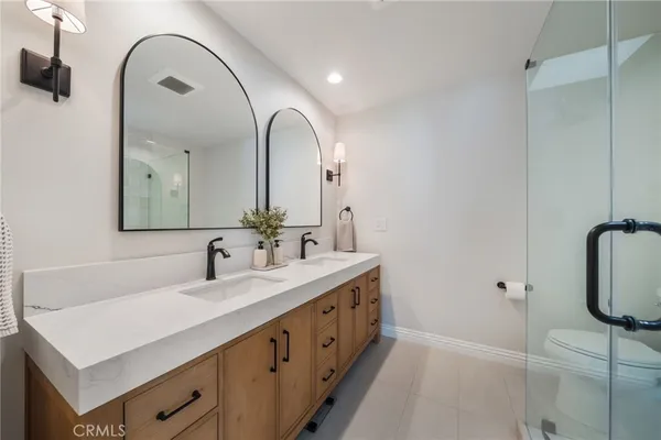 a bathroom with a double vanity sink and mirror