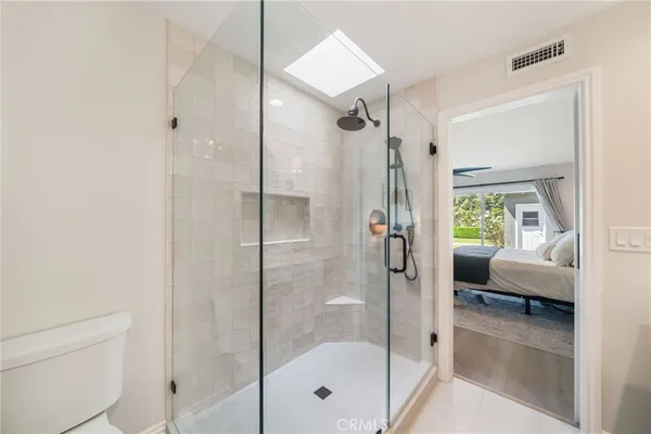 a bathroom with a glass shower door