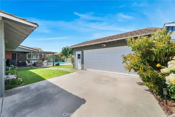 a view of house with outdoor space and swimming pool