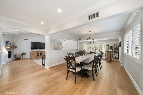 a dining room with furniture window and wooden floor
