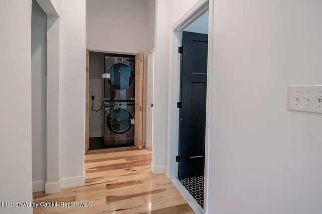 a view of a hallway and a livingroom with wooden floor