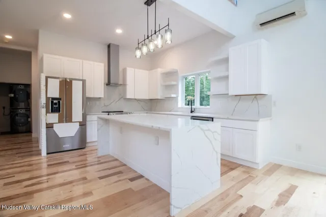 a kitchen with kitchen island a sink stainless steel appliances and cabinets