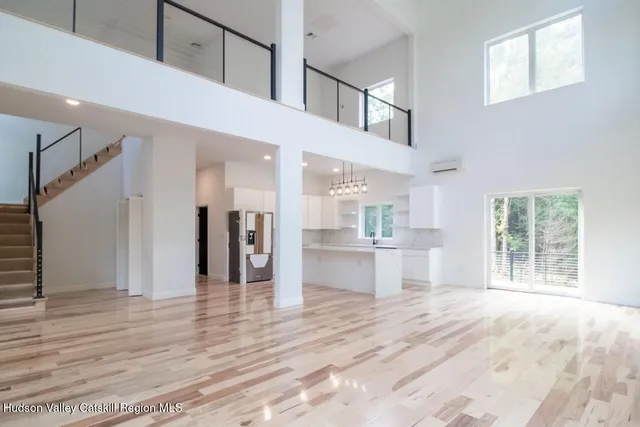 a view of a kitchen with wooden floor and a window