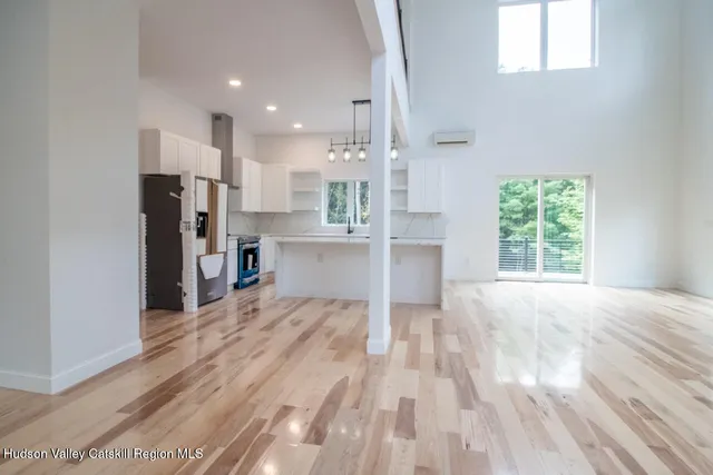 a view of a kitchen with wooden floor and windows