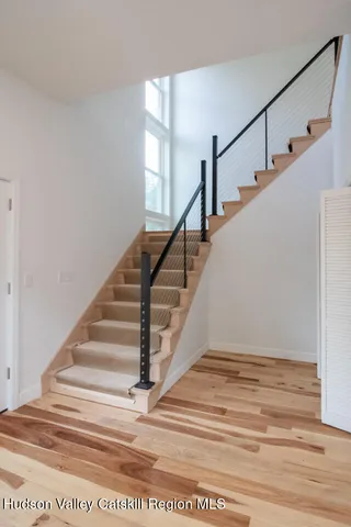a view of entryway and hall with wooden floor
