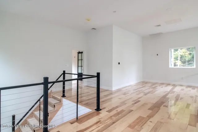 a view of a room with wooden floor