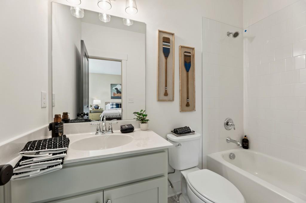 4510 Aiden Way Cumming, GA 30041 - Photo 23 of 53 a bathroom with a sink a toilet and a mirror