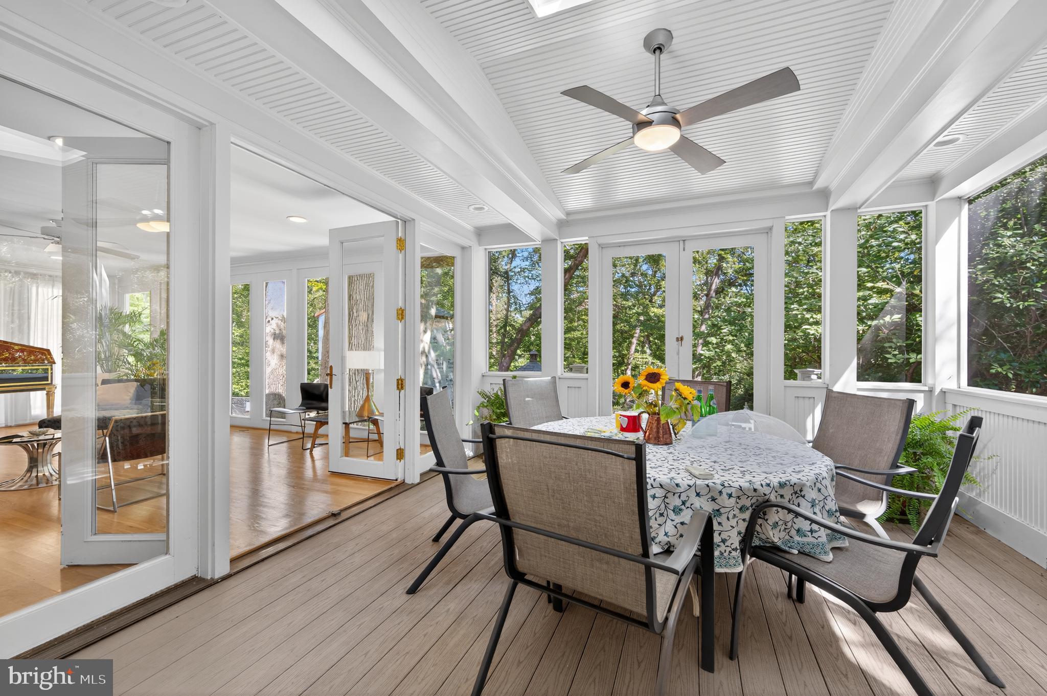 3137 Aberfoyle Place Northwest Washington, DC 20015 - Photo 18 of 85 a view of a dining room with furniture large windows and wooden floor