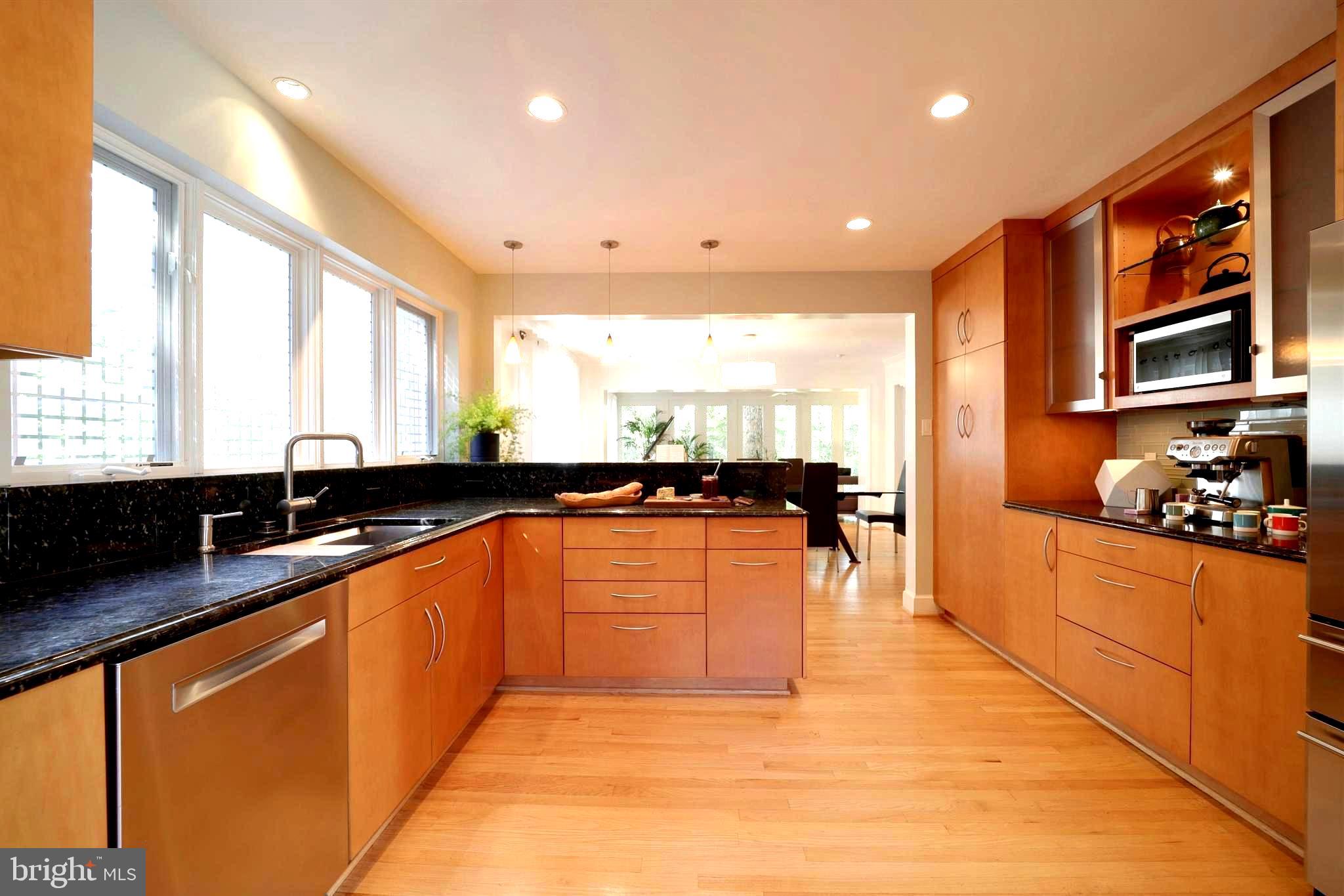 3137 Aberfoyle Place Northwest Washington, DC 20015 - Photo 27 of 85 a large kitchen with stainless steel appliances granite countertop a sink and cabinets