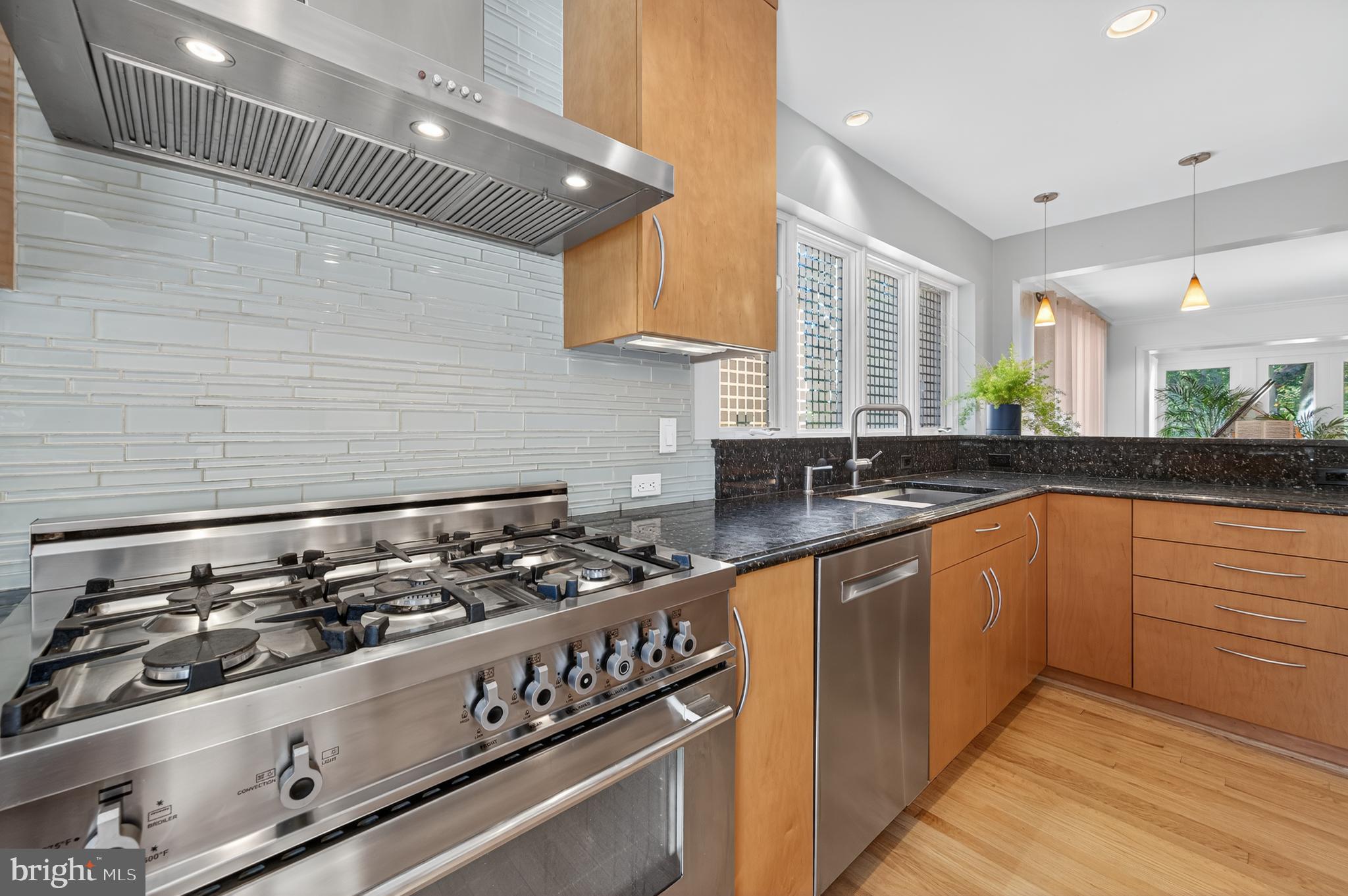 3137 Aberfoyle Place Northwest Washington, DC 20015 - Photo 31 of 85 a kitchen with granite countertop stainless steel appliances a sink stove and cabinets