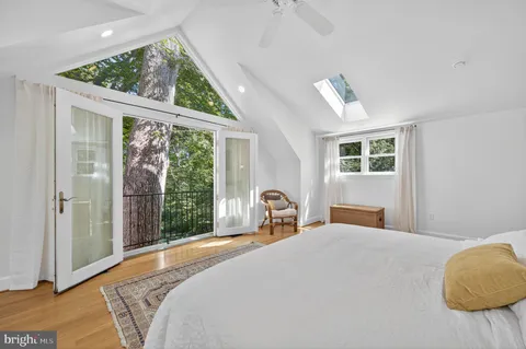 a bedroom with a bed and a painting on the wall